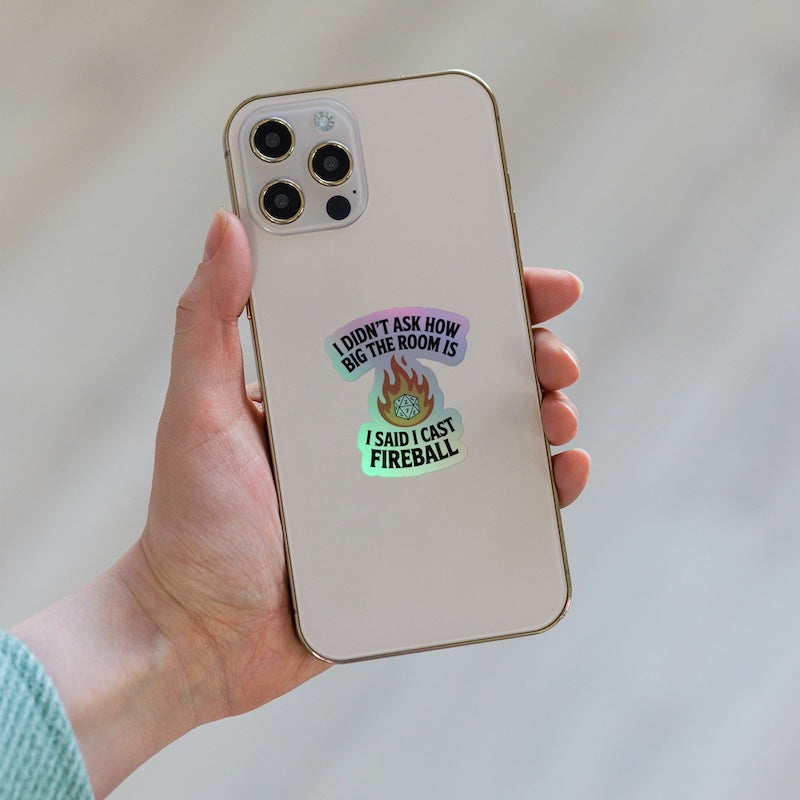 Phone case with humorous text and graphic design held by a hand