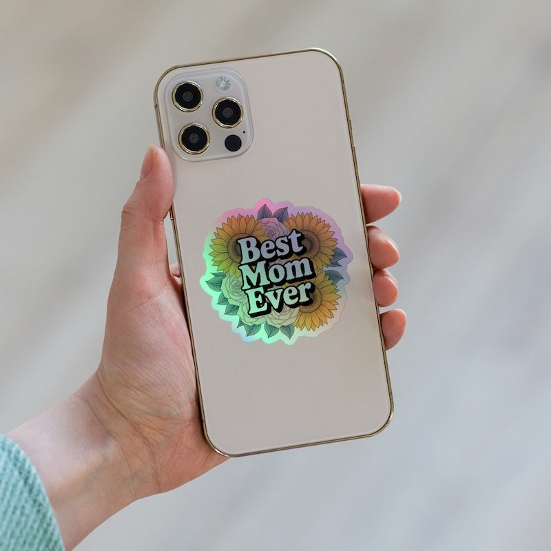 Phone case with 'Best Mom Ever' sticker held by a hand
