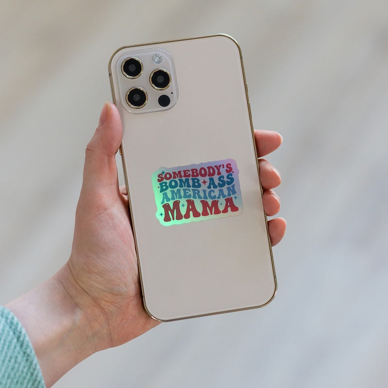 Phone case with 'Somebody's Bomb-Ass American Mama' text held by a hand