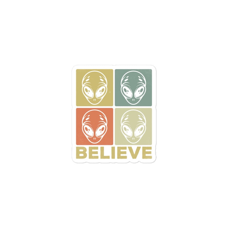 Sticker with alien heads and 'BELIEVE' text on a white background