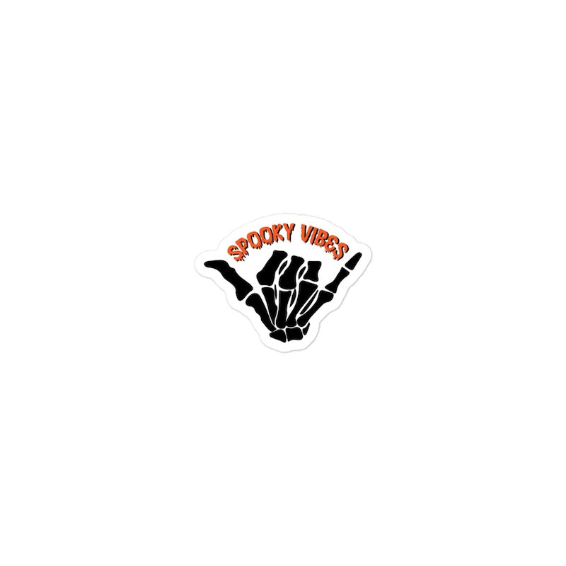 Sticker with skeleton hand and 'Spooky Vibes' text on a white background