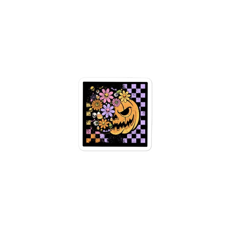 Halloween-themed design with a jack-o'-lantern and flowers on a black background
