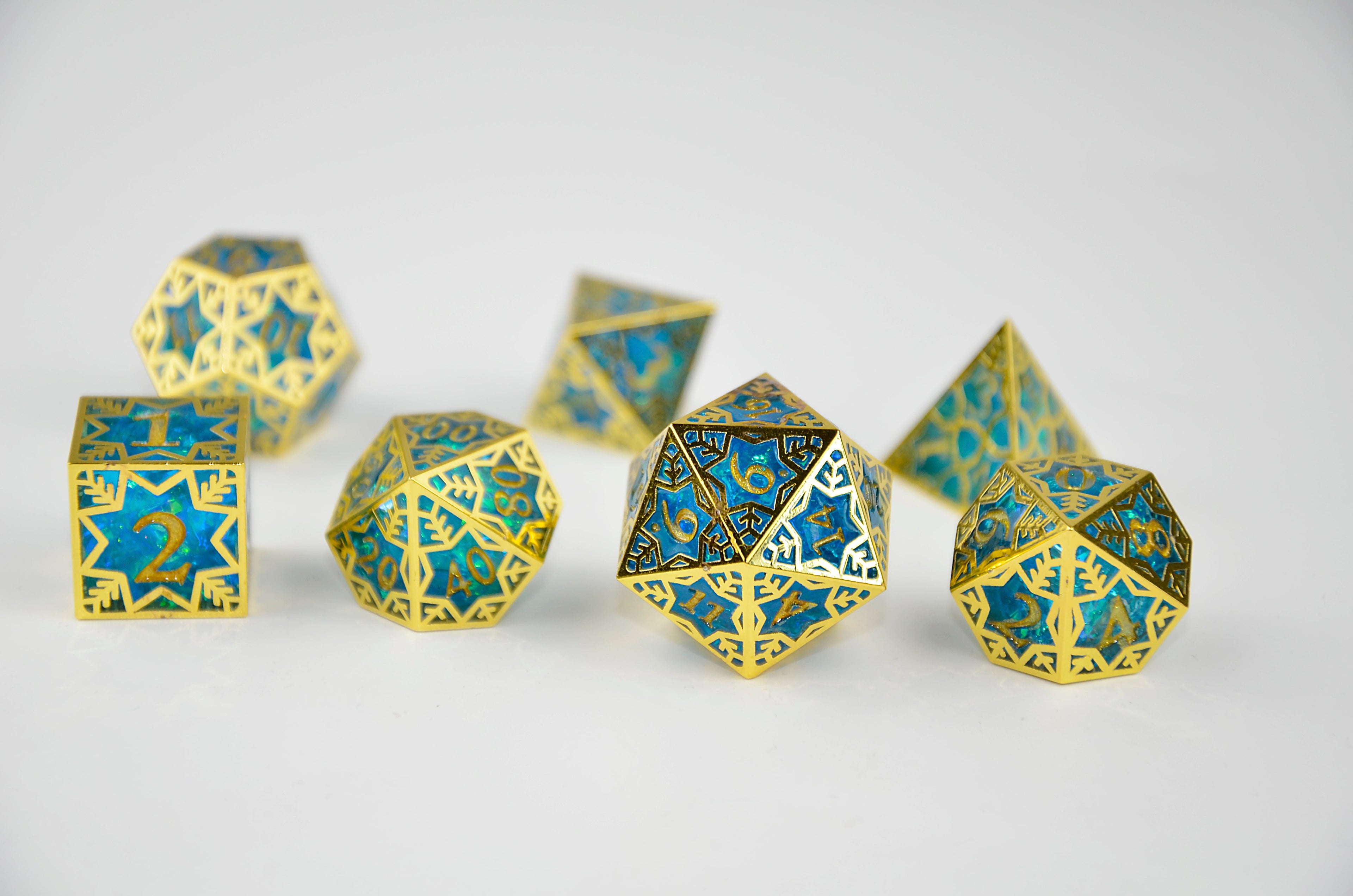 Gold and blue polyhedral dice on a white background