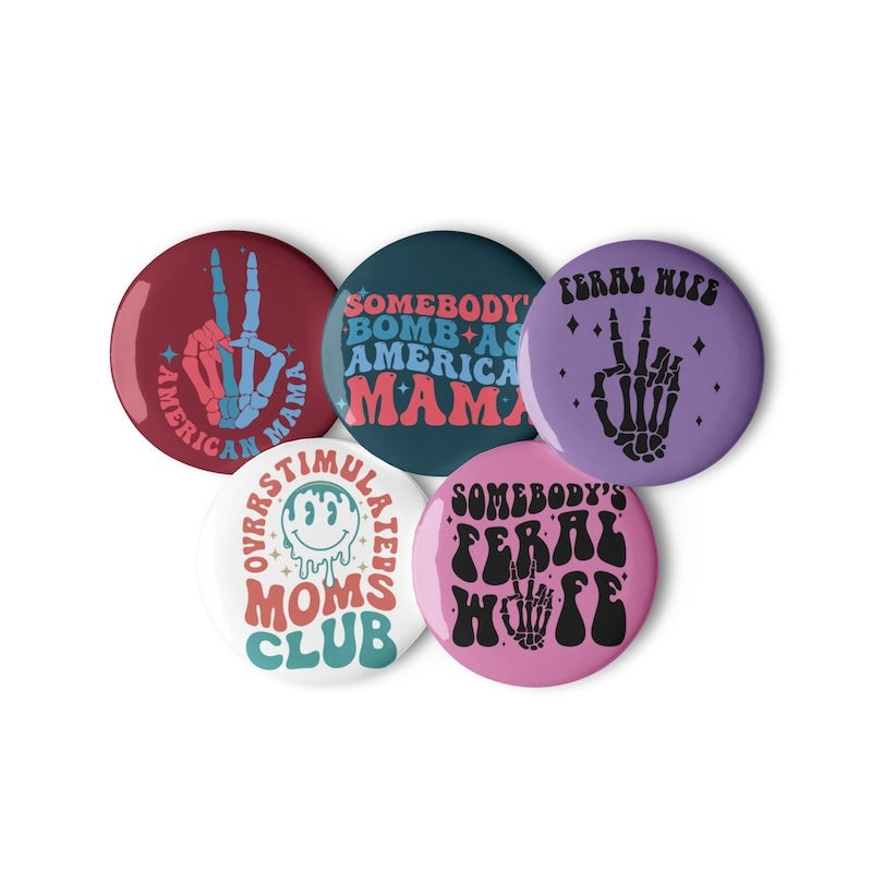 Set of five colorful buttons with various designs on a white background