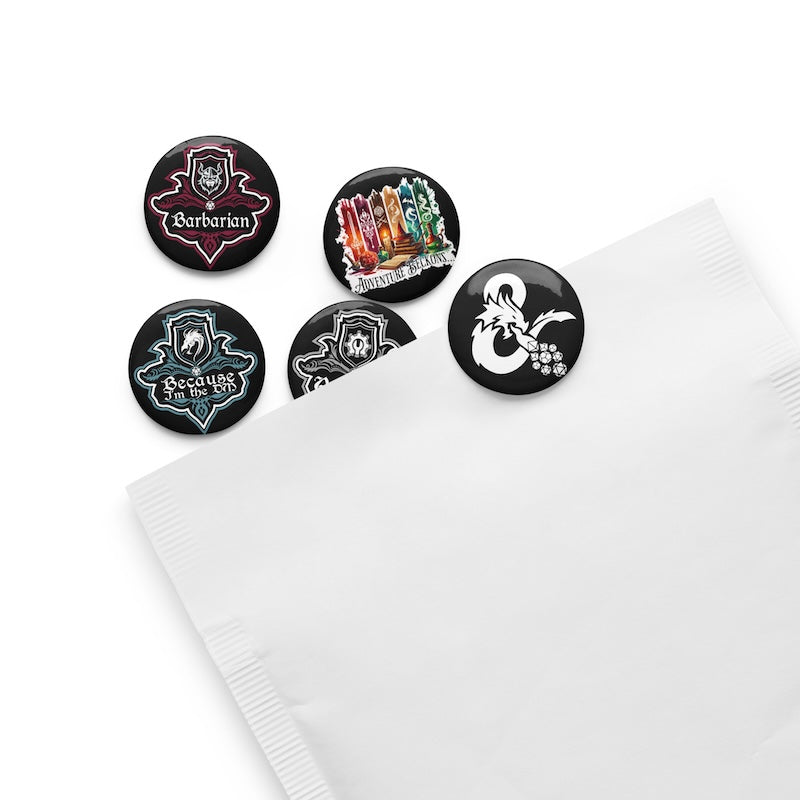 Set of five themed buttons on a white surface