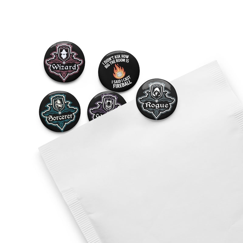 Set of five themed buttons on a white napkin