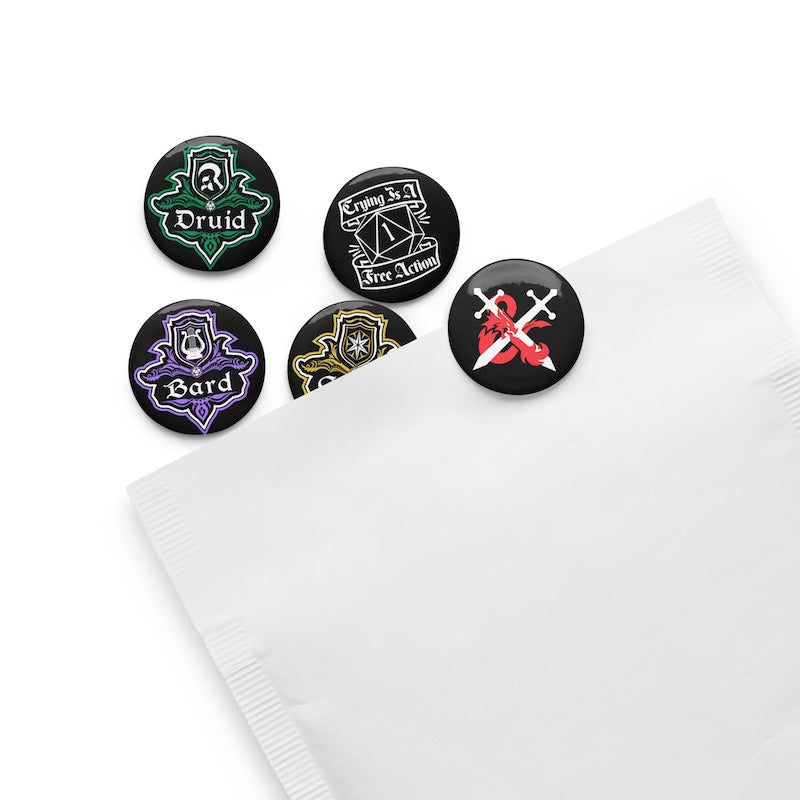 Set of five character class buttons on a white napkin