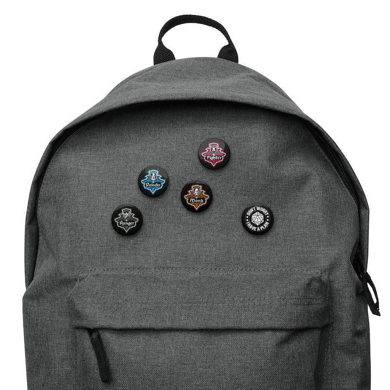 Gray backpack with various pins on a white background