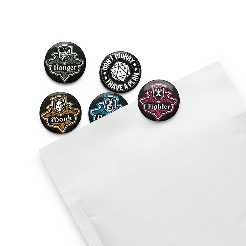 Set of five character class buttons on a white napkin
