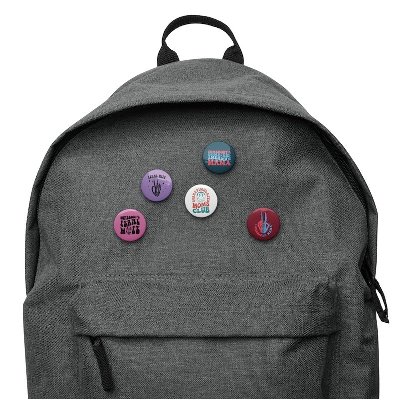 Gray backpack with colorful buttons on a white background