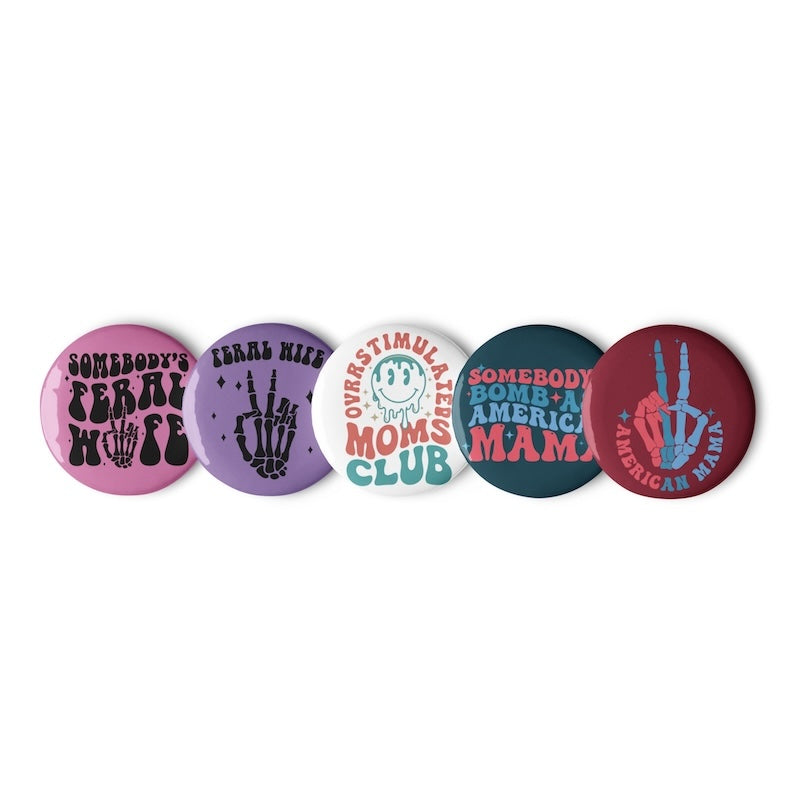 Set of five buttons with various designs and text on a white background