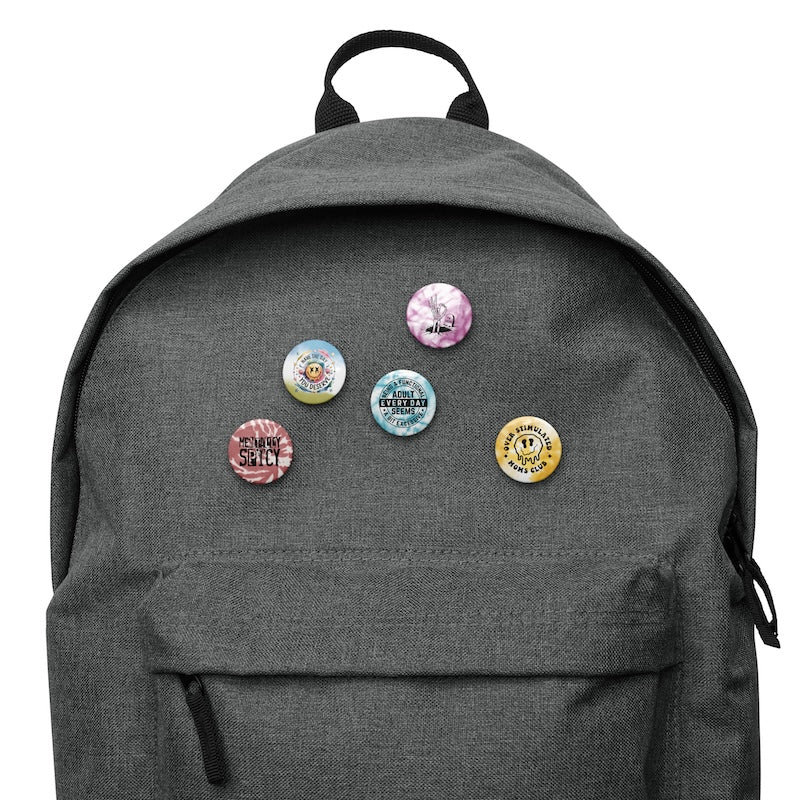 Gray backpack with colorful buttons on a white background