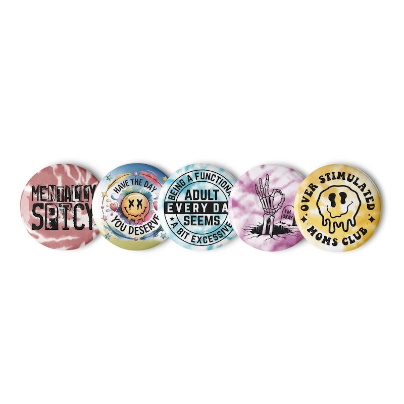 Set of five colorful buttons with various designs and text on a white background