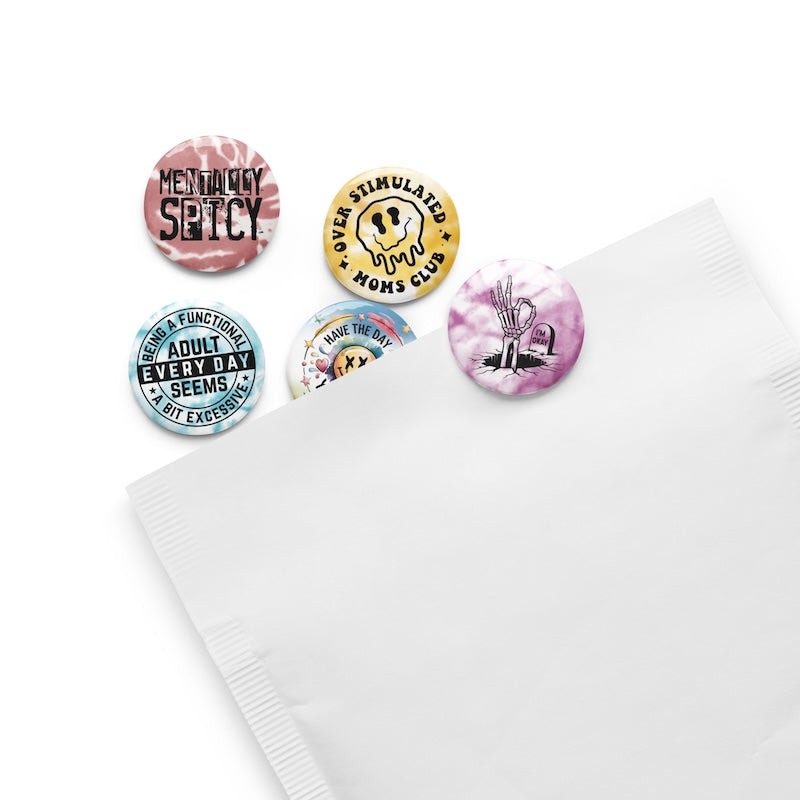 Set of colorful buttons with various designs on a white surface