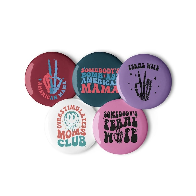 Set of five colorful buttons with various designs on a white background