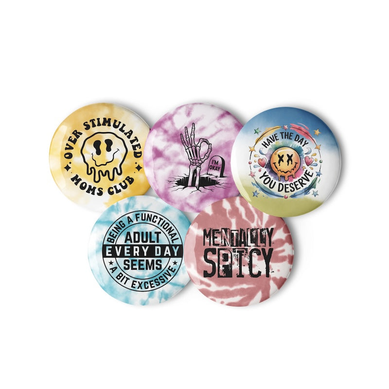 Set of colorful buttons with various designs and text on a white background