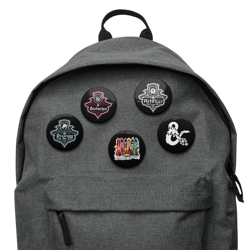 Gray backpack with five round patches featuring different designs on a white background