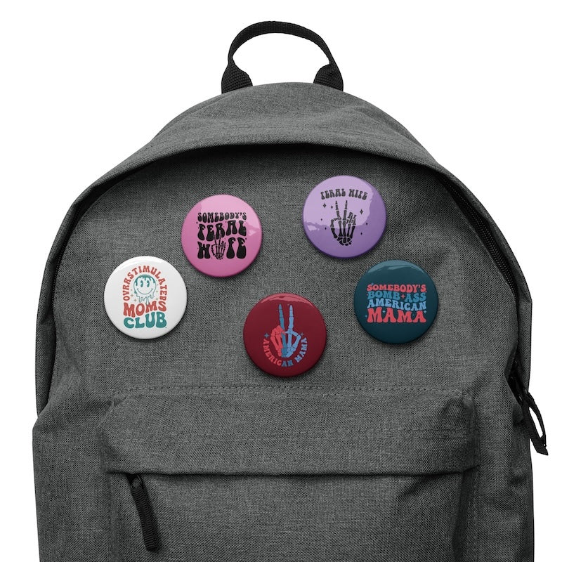 Gray backpack with colorful buttons on a white background