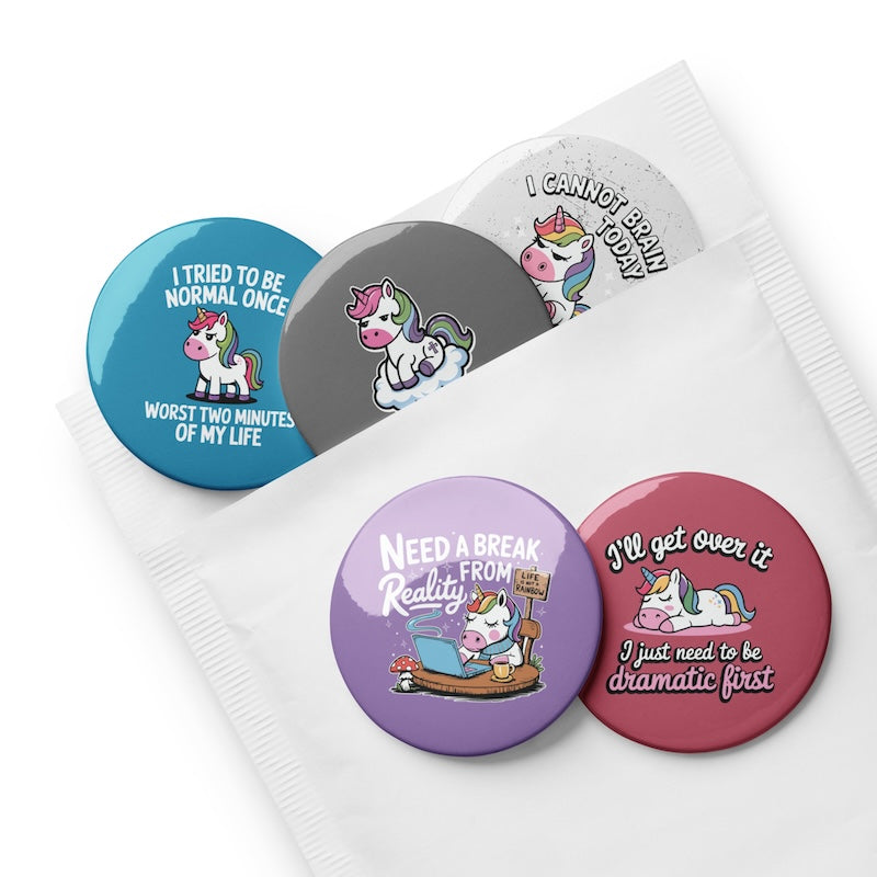 Set of colorful buttons with unicorn illustrations and humorous text on a white background