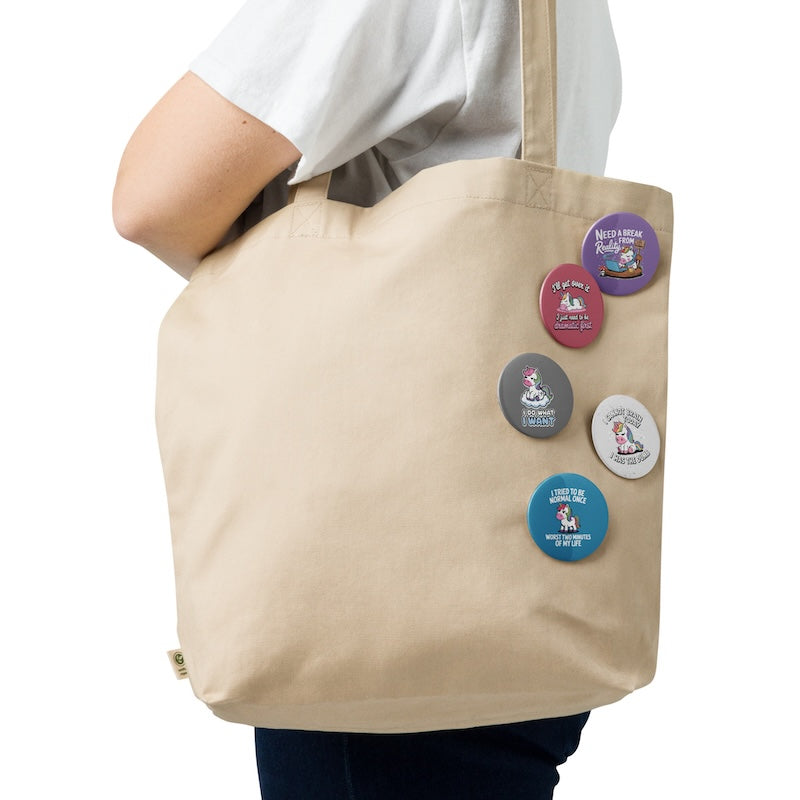 Beige tote bag with colorful buttons on a white background
