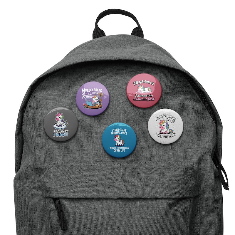 Gray backpack with colorful buttons featuring various designs and text.