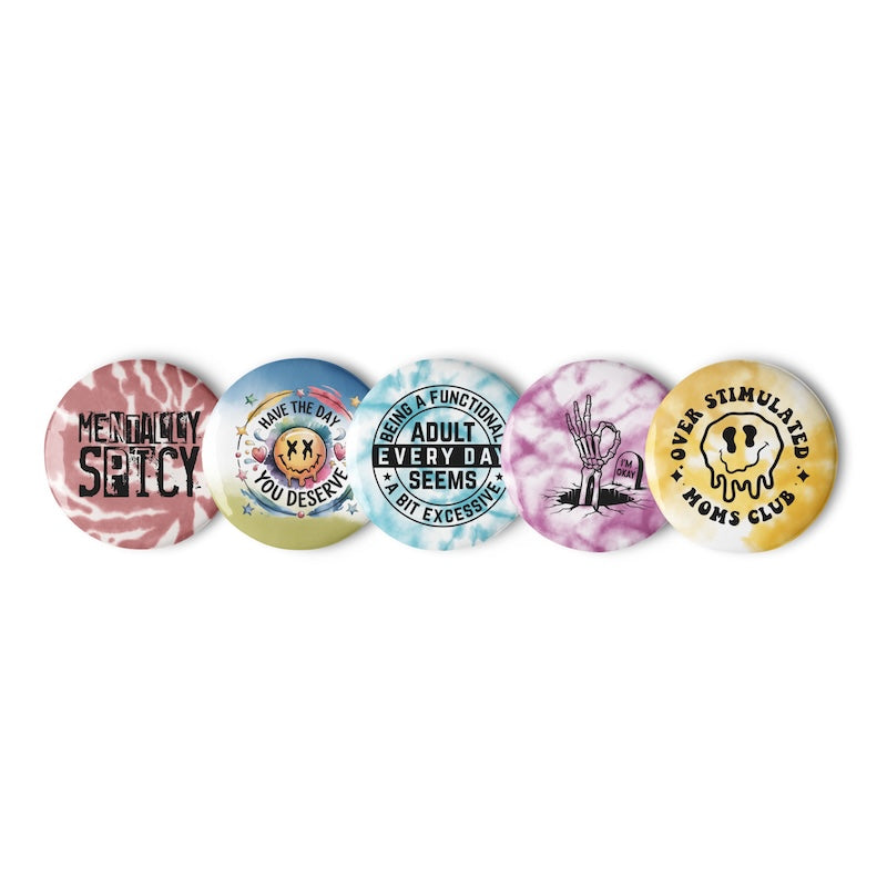 Set of five colorful buttons with various designs and text on a white background