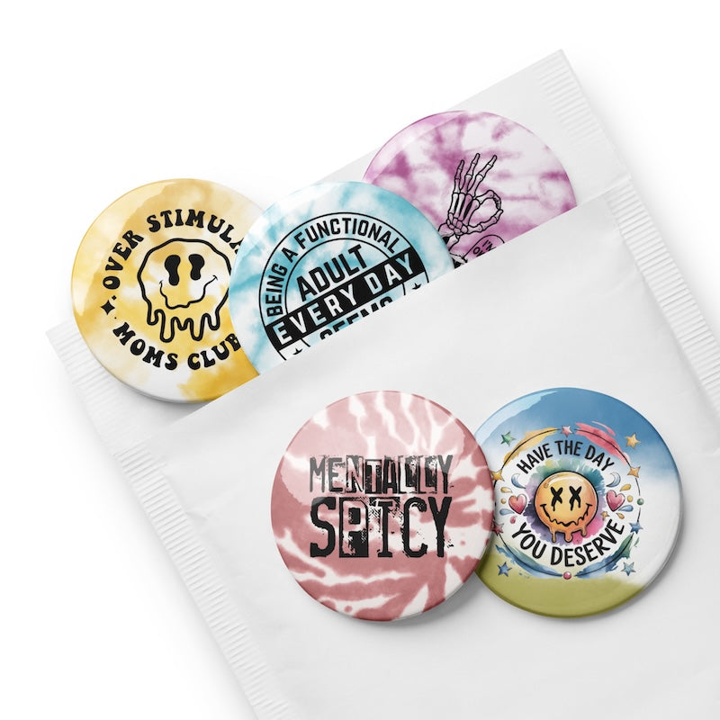 Set of colorful buttons with various designs and text on a white background