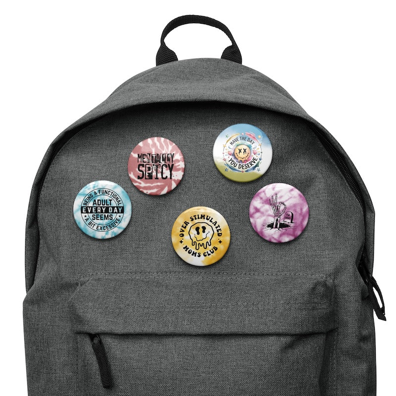 Gray backpack with colorful buttons on a white background