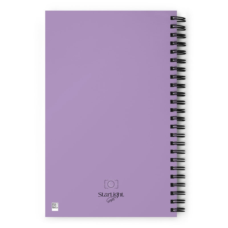 Purple notebook with spiral binding on a white background
