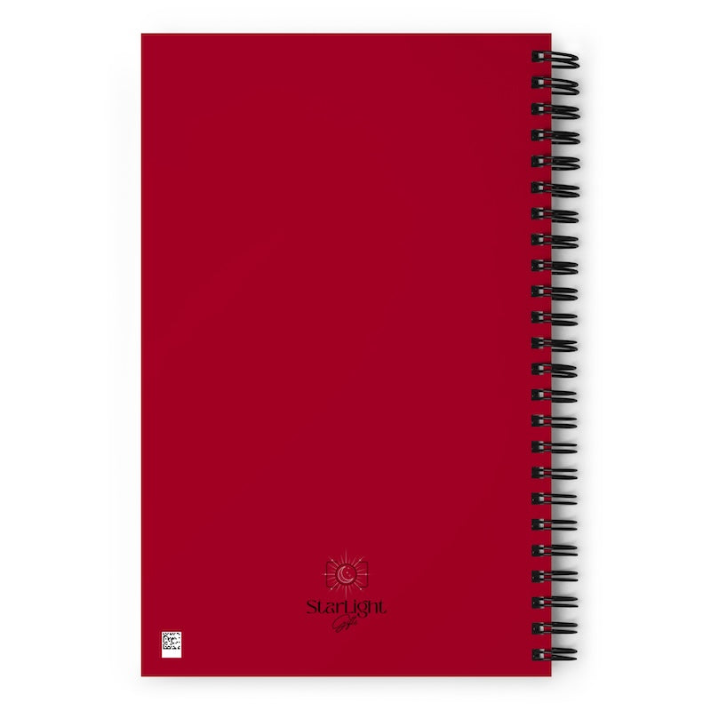 Red notebook with a spiral binding on a white background