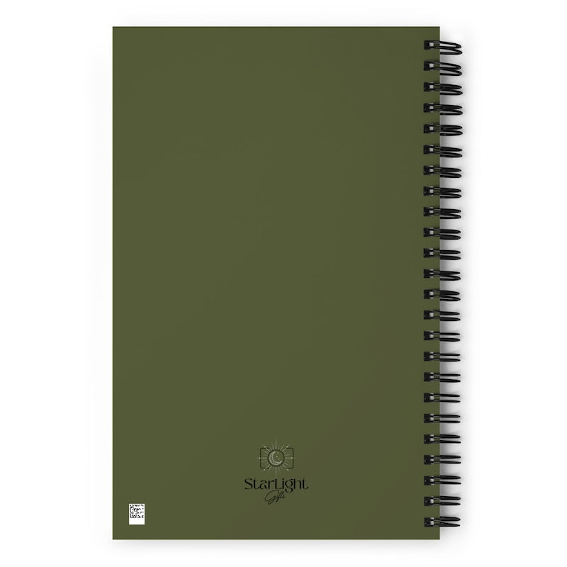 Green notebook with spiral binding on a white background