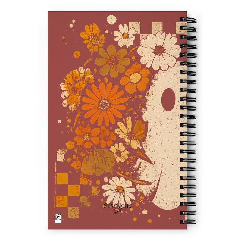 Notebook with floral design on a red-brown background