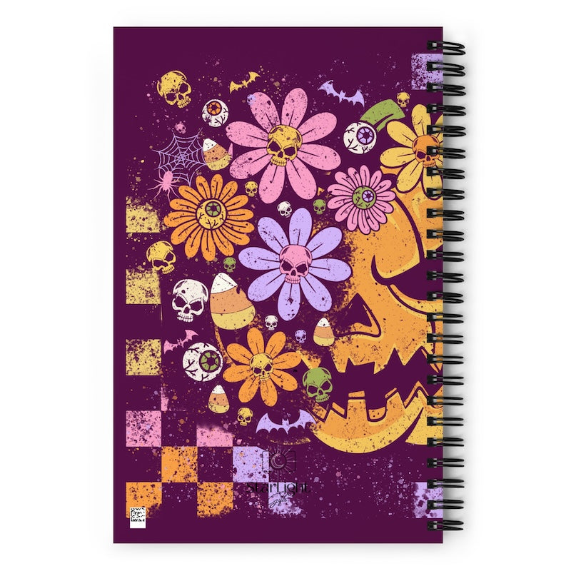 Spiral-bound notebook with Halloween-themed design on a purple background