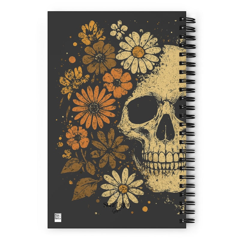 Notebook with a skull and floral design on a black background