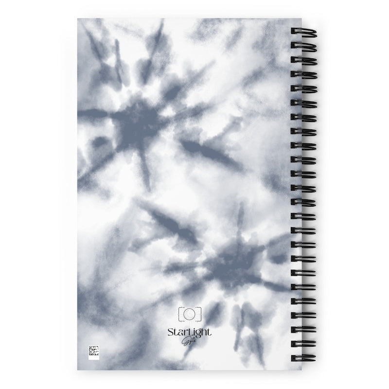 Spiral-bound notebook with tie-dye design and 'Starlight' branding on a white background