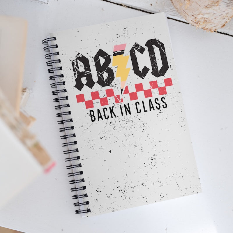 Notebook with 'AB CD Back in Class' design on a white surface