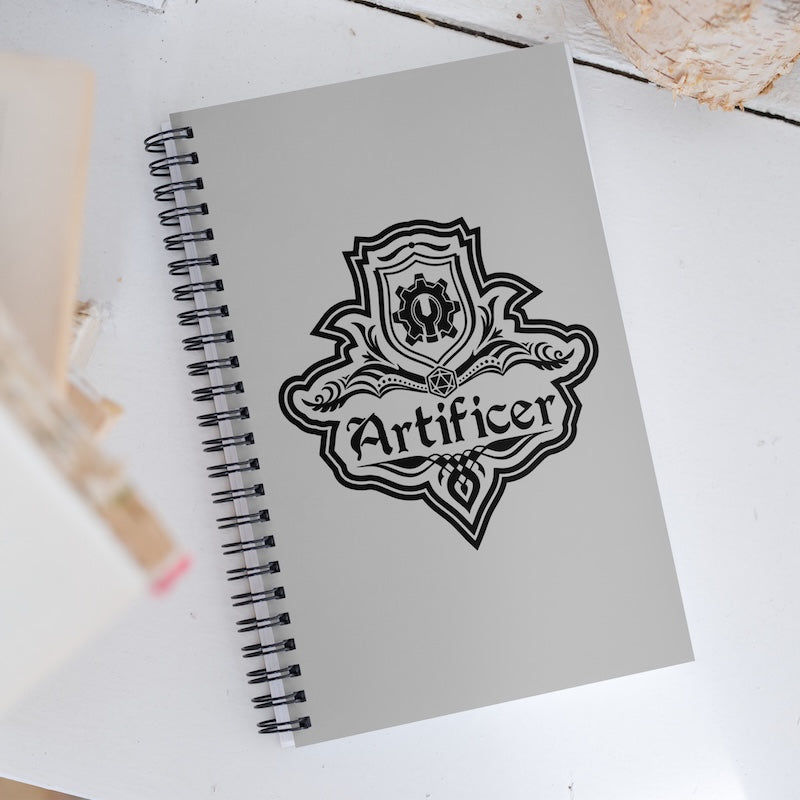 Notebook with 'Artificer' emblem on a light background