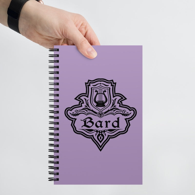 Purple notebook with 'Bard' emblem held by a hand on a light gray background