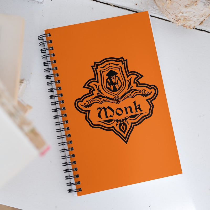 Orange notebook with 'Monk' logo on a white surface