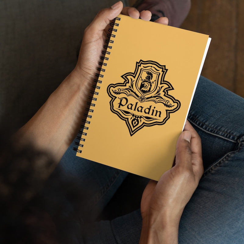 Yellow notebook with 'Paladin' logo held by a person