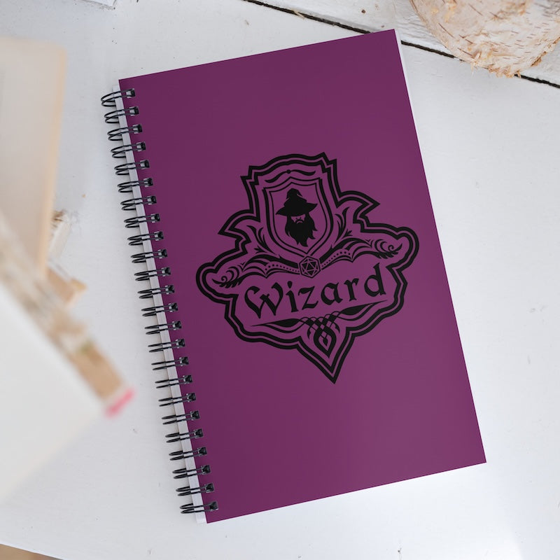 Purple notebook with 'Wizard' design on a white surface