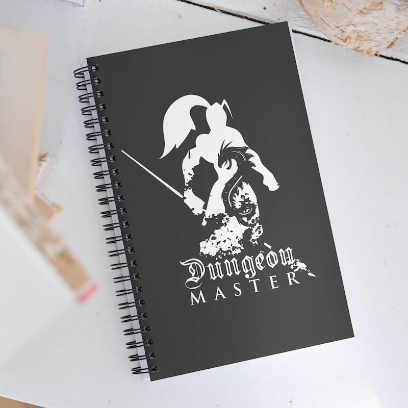 Black notebook with 'Dungeon Master' design on a white surface