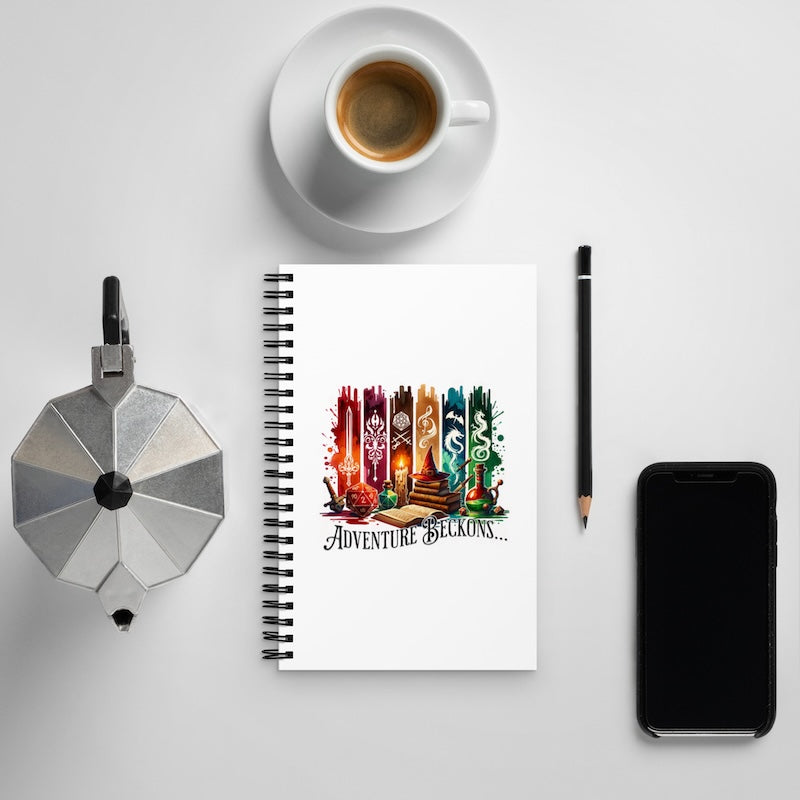 Notebook with travel-themed design, coffee cup, pen, and phone on a light gray background