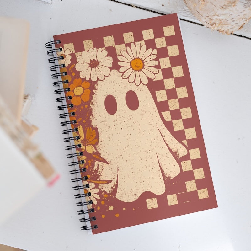Notebook with ghost and floral design on a checkered background