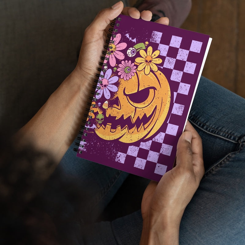 Notebook with Halloween-themed design held by a person