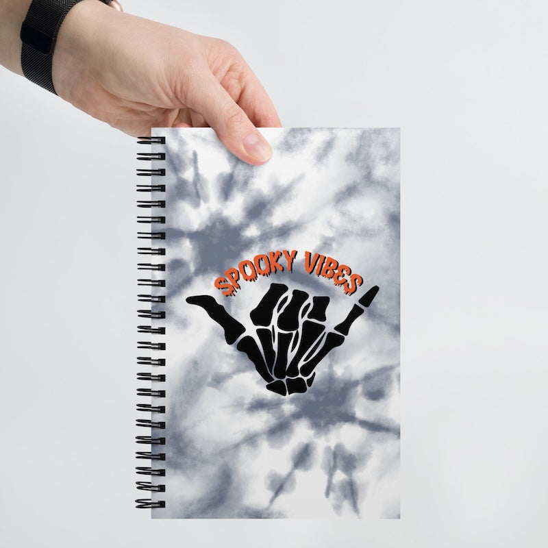 Notebook with 'Spooky Vibes' design on a marble background