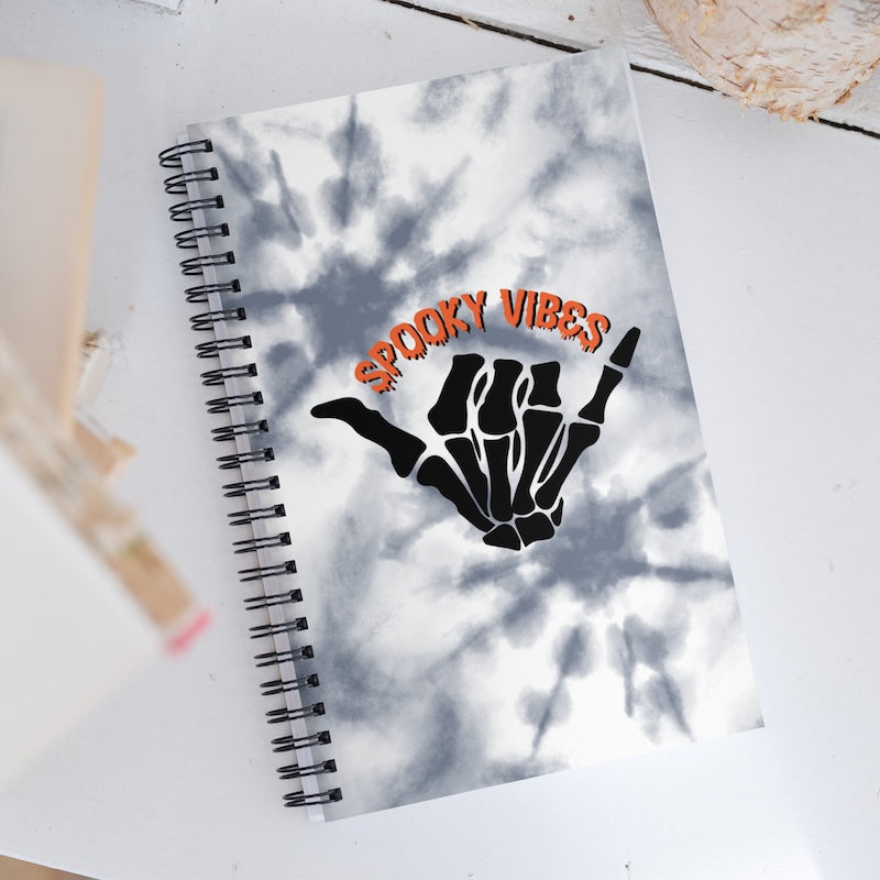 Notebook with 'Spooky Vibes' design on a white surface