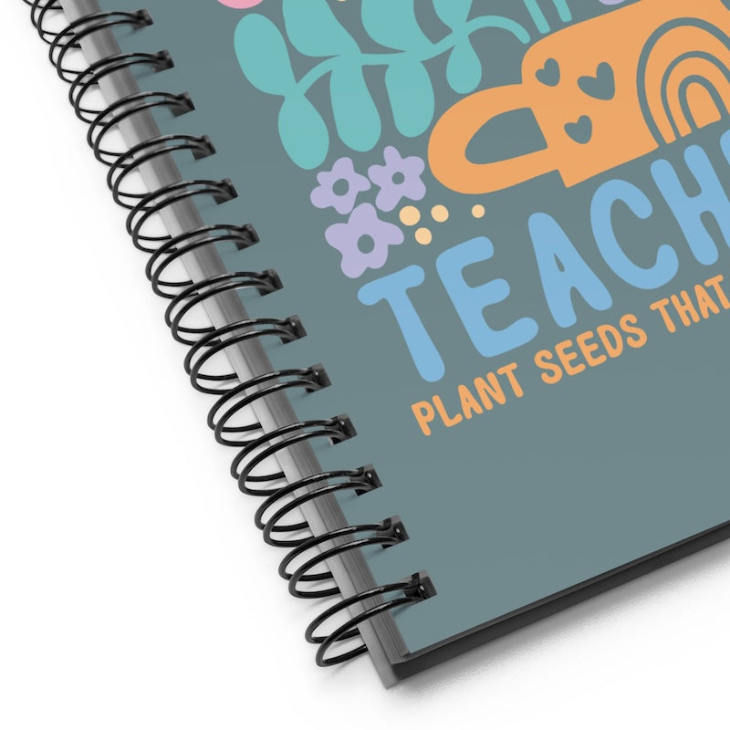 Spiral-bound notebook with colorful design and text on a white background