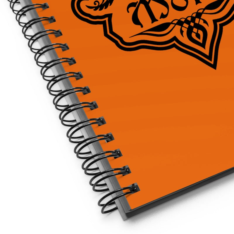 Spiral-bound notebook with orange cover and black design on a white background