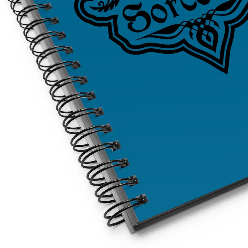Blue notebook with a spiral binding on a white background